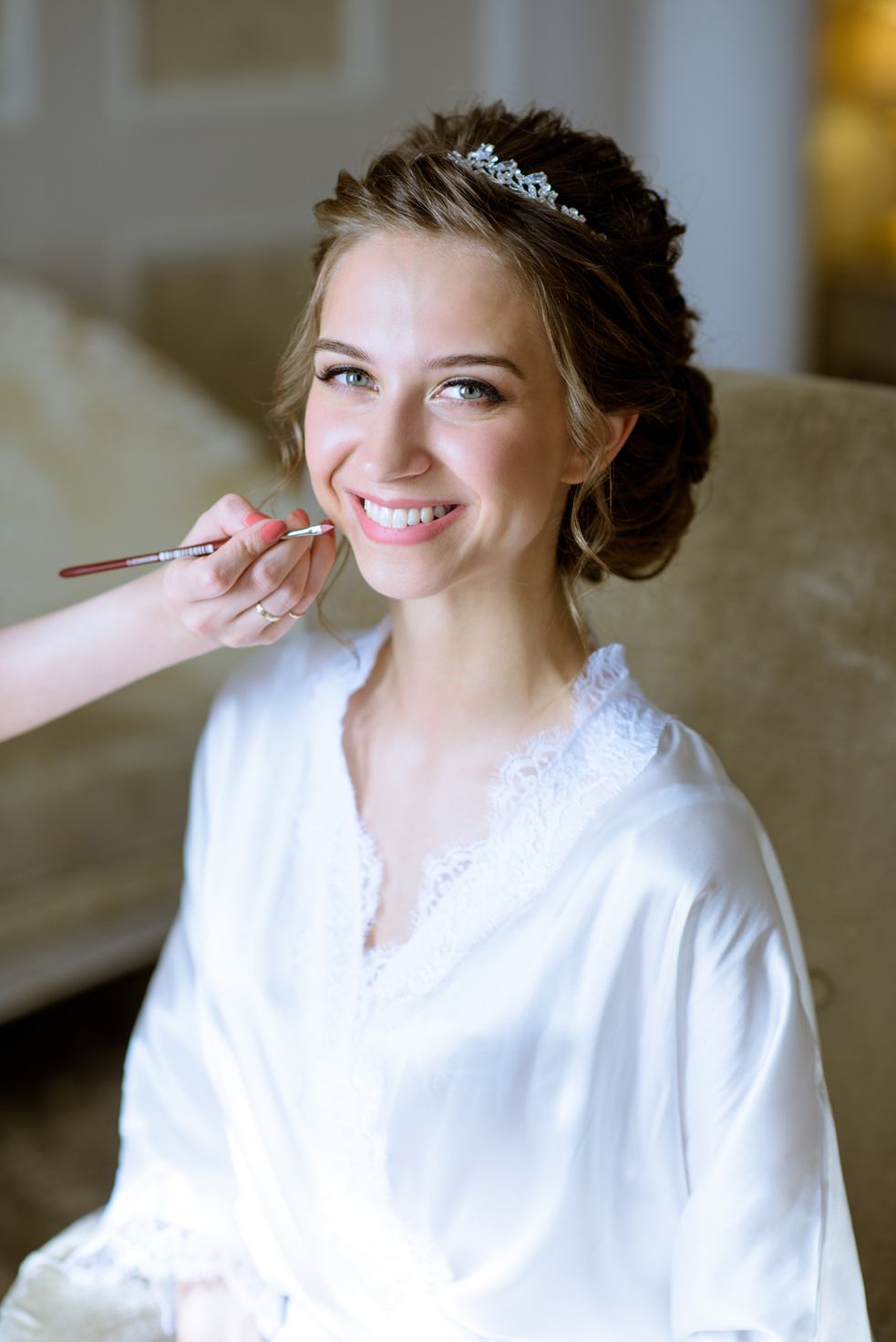 Wedding makeup artist making a make up for bride